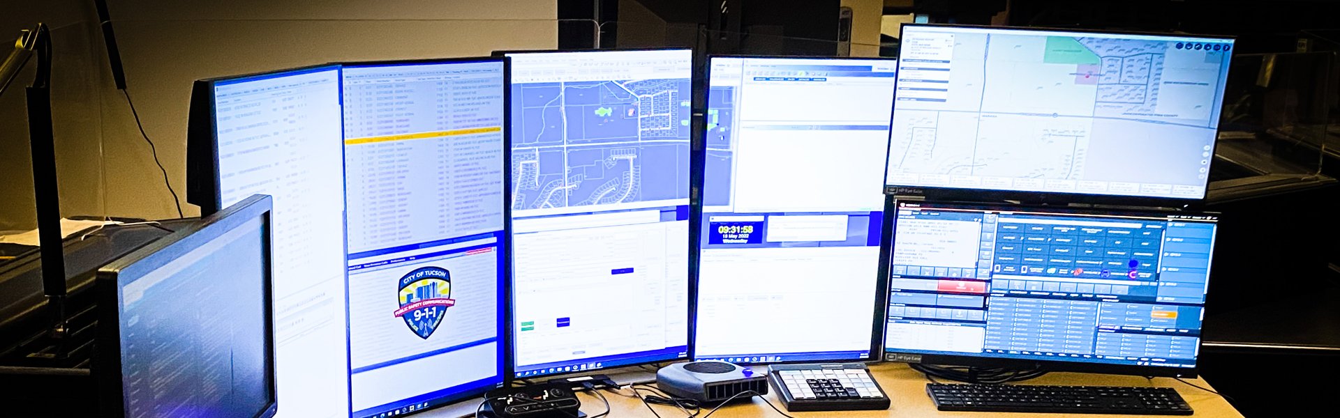 5-7 computer monitors set up for 911 command center